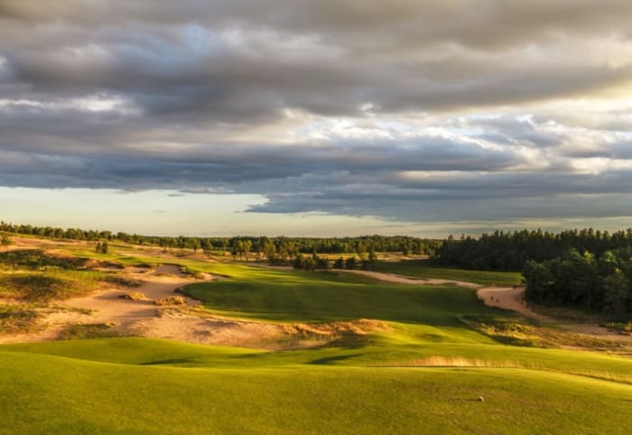 The Wisconsin property for Sand Valley was once covered by a non-native pine forest that existed for the purpose of being harvested for the area paper mills. Today, the Bill Coore-Ben Crenshaw design is considered among the nation's premier courses. Shown is Sand Valley's first hole.